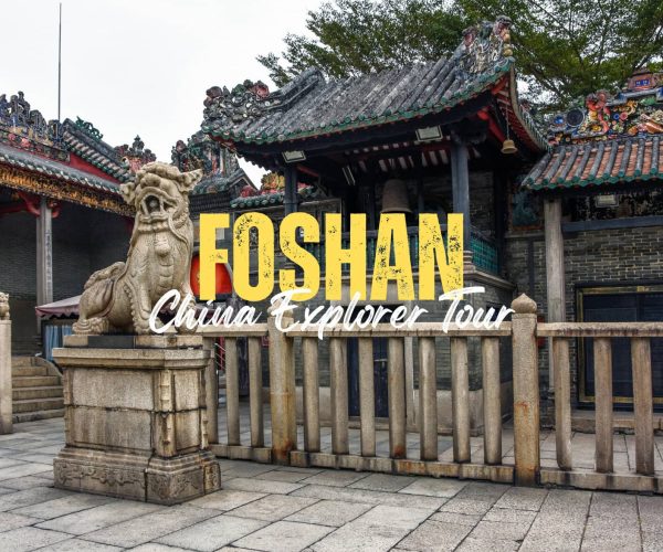 Foshan,Guangdong,Chinatravel Promotional banner reading 'FOSHAN China Explorer Tour' over a traditional Chinese temple entrance with a stone guardian lion statue in front.