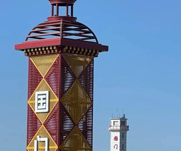 Manzhouli Border Gate,Hulunbuir,Chinatrip Colorful lattice tower with red and yellow diamond patterns and a domed top against a clear blue sky; Chinese characters visible on the tower.