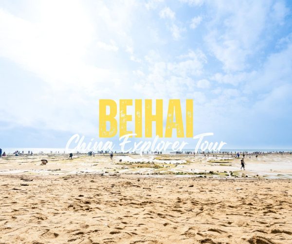 Beihai,Guangxi,Chinatravel Wide beach scene with a blue sky and many people, featuring a bold yellow 'BEHAI' and white cursive 'China Explorer Tour' overlay promoting a tour.