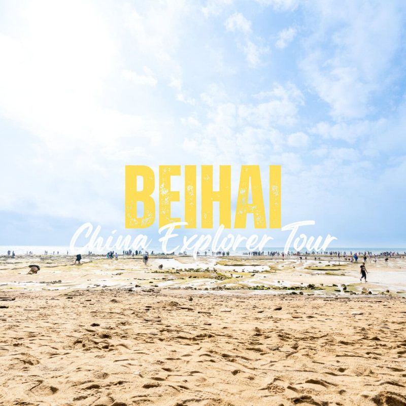 Beihai,Guangxi,Chinatravel Wide beach scene with a blue sky and many people, featuring a bold yellow 'BEHAI' and white cursive 'China Explorer Tour' overlay promoting a tour.