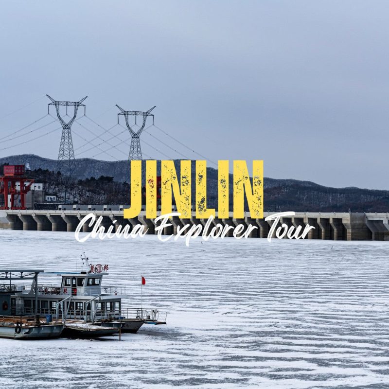 Jilin,Jilin Province,China tour Promotional banner for JINN China Explorer Tour showing a dam and a boat on a river with branding text.