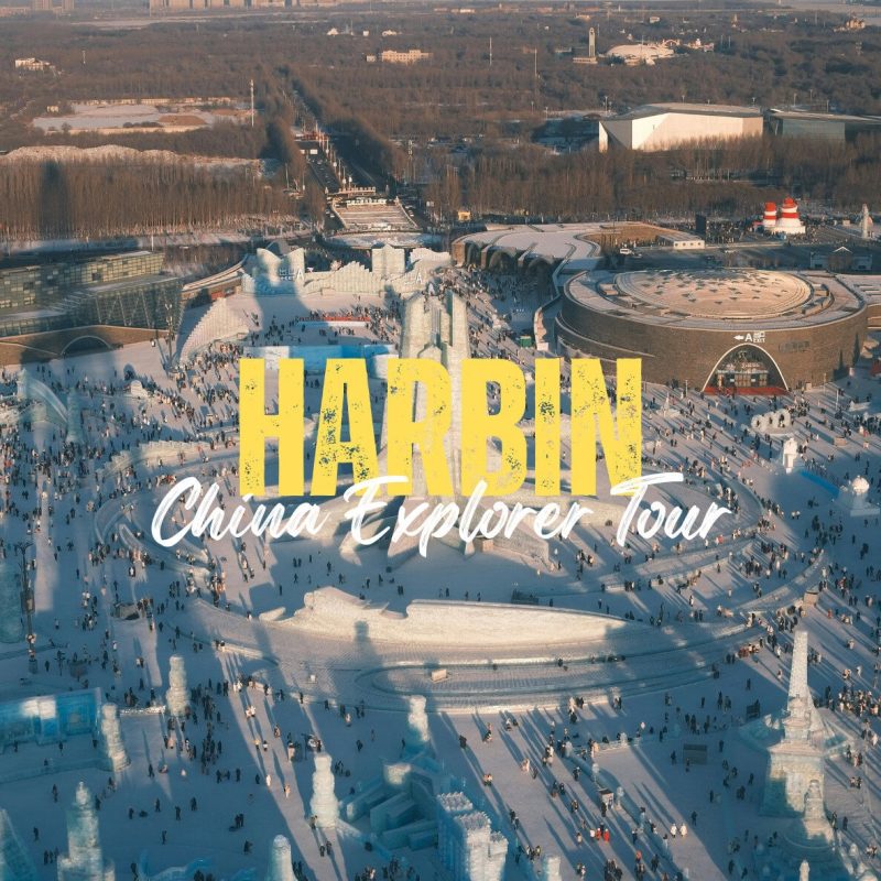 Harbin,Heilongjiang,Chinatravel Aerial view of Harbin Ice and Snow World with huge yellow 'HARBIN' title and white 'China Explorer Tour' text over a frozen plaza filled with people.