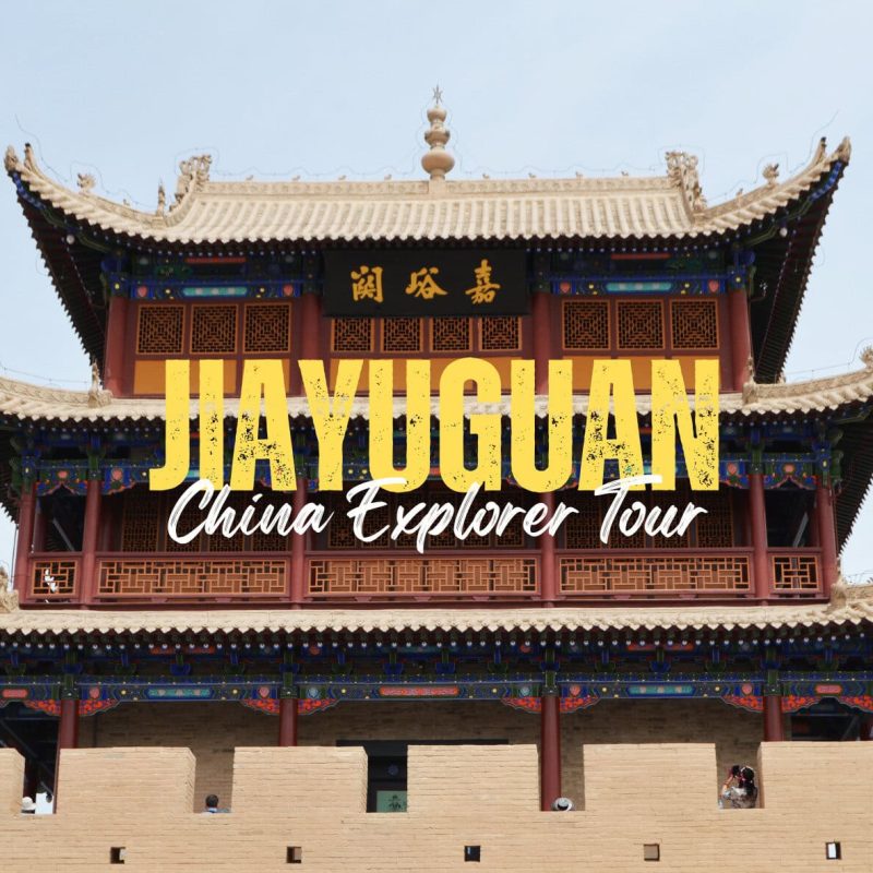 Jiayuguan,Gansu,China tour Promotional photo of a traditional Chinese building with bold yellow text reading 'JIA YU GUAN' and white script 'China Explorer Tour' overlaying the façade.