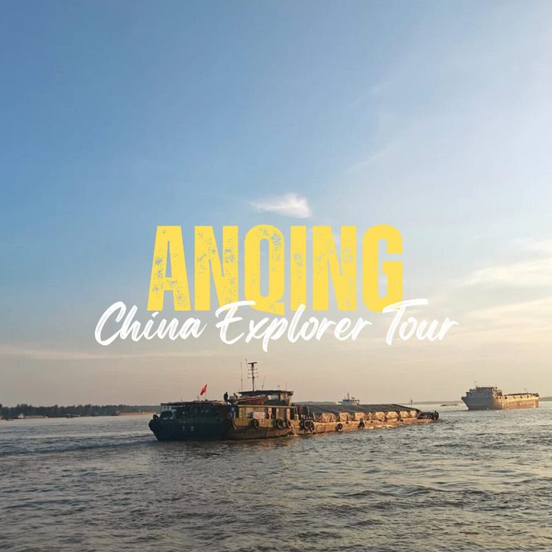Anqing,Anhui,China tour Promotional banner for 'ANONG China Explorer Tour' on a calm river with large yellow text and boats in the background.