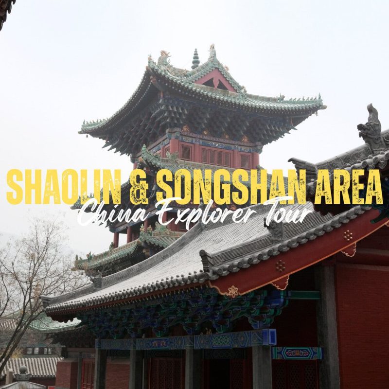 Shaolin&Songshan Area,Henan,Chinatravel Promotional banner for a Shaolin and Songshan area tour over a traditional Chinese temple facade with ornate green roofs and bright yellow text reading 'SHAOLIN & SONGSHAN AREA' and white script 'China Explorer Tour'
