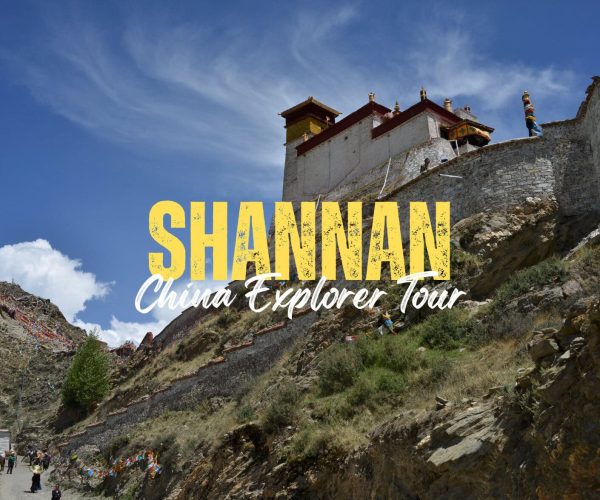 Shannan,Tibet,China tour Promotional image: hillside fortress with blue sky, large yellow 'SHANNAN' text and white 'China Explorer Tour' subtitle overlaying the scene.