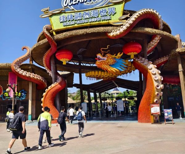 Guilin Ocean World,Guilin,Chinatravel Entrance to Sunac Ocean Park with a dragon sculpture, red lanterns, and visitors entering on a sunny day.