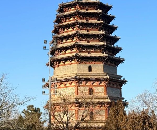 Zhengding Ancient City,Shijiazhuang,China tour Seven-story Chinese pagoda with curved eaves and decorative top, brick and stone construction against a clear blue sky.