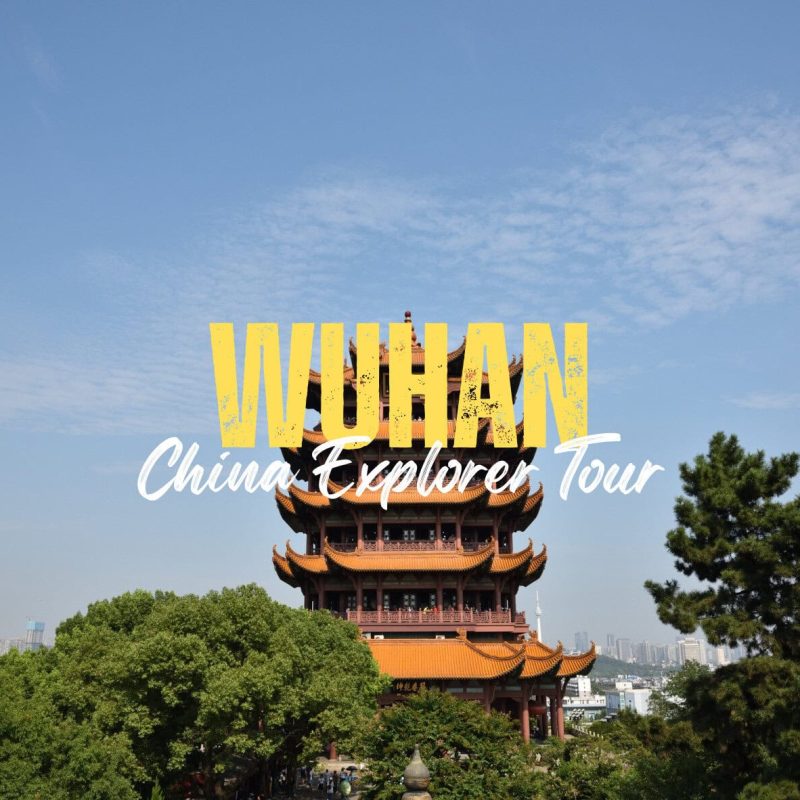 Wuhan,Hubei,Chinatravel Text overlay reading 'VUHAN China Explorer Tour' over a traditional Chinese pagoda with trees and a city skyline behind it.