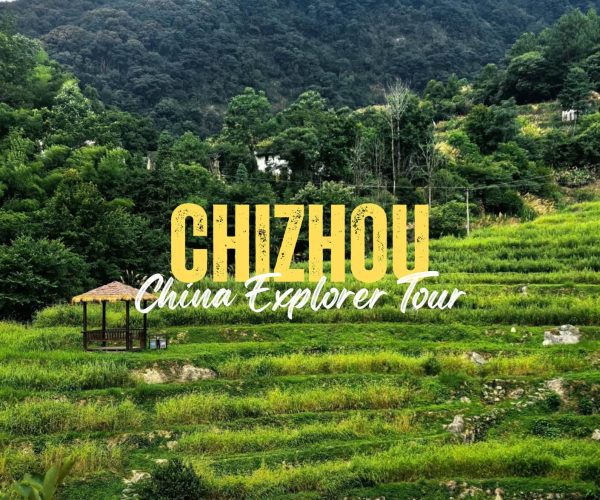 Chizhou,Anhui,China tour Terraced green fields with a small gazebo and bold yellow 'CHIZHOU' tour branding overlay: 'China Explorer Tour'