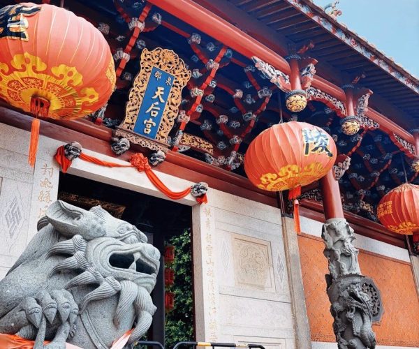 Quanzhou Tianhou Temple,Quanzhou,Chinatravel Ornate Chinese temple entrance with red lanterns, carved dragons, and a blue plaque with Chinese characters.