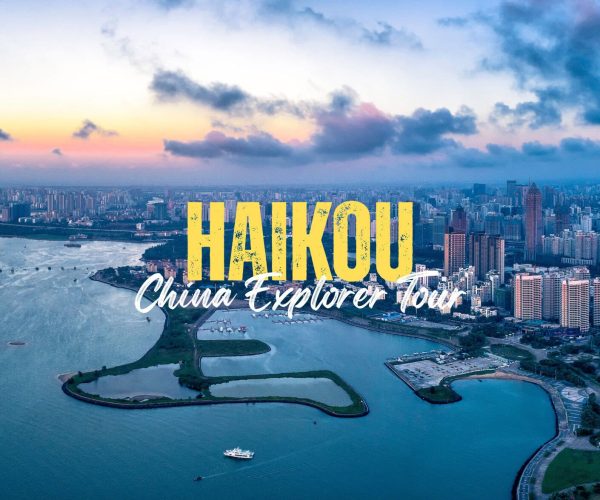 Haikou,Hainan,Chinatravel Aerial view of Haikou city along a waterway with a park island in the foreground and bold yellow text 'HAIKOU' with white script 'China Explorer Tour' overlaid.