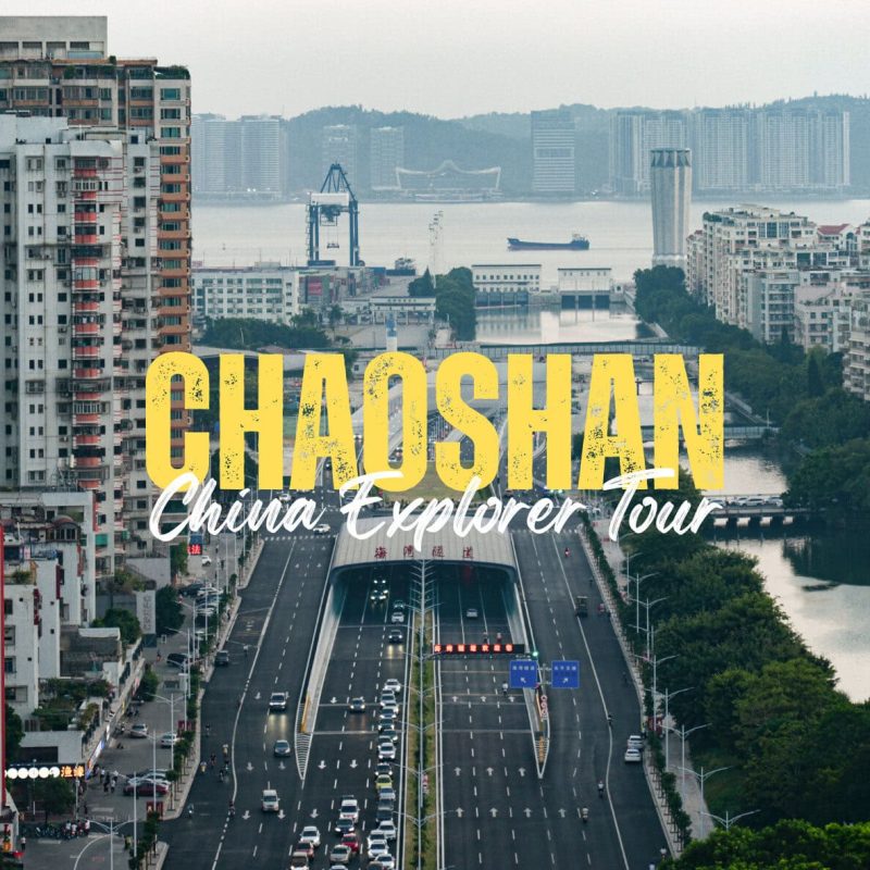 Chaoshan,Guangdong,Chinatravel Cityscape with a wide boulevard, river, and high-rise buildings; bold yellow text reads 'CHAO SHAN' and 'China Explorer Tour'.