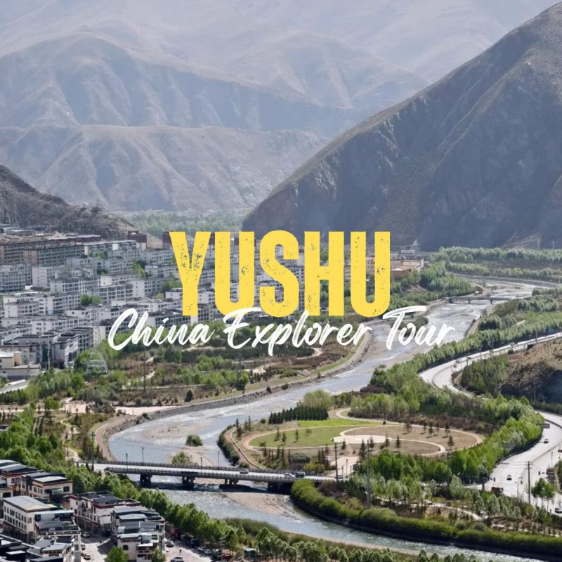 Yushu,Qinghai,China tour Promotional image for Yushu China Explorer Tour, showing a river valley with a town at the base of mountains and bold yellow text 'YUSHU' overlaid.
