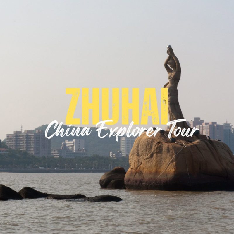 Zhuhai,Guangdong,Chinatravel Tour poster for Zhuhai featuring the statue on a rock in the bay, with a city skyline in the background and the yellow 'ZHUHAI' plus 'China Explorer Tour' script overlay.