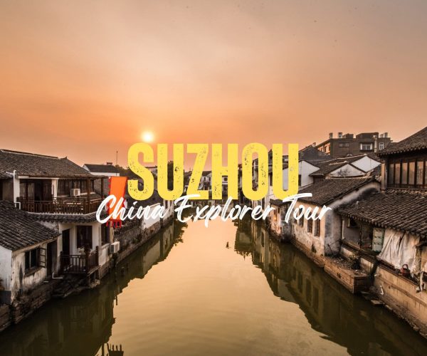 Suzhou,Jiangsu,China tour Sunset over a historic Suzhou canal with bold yellow text reading 'SUZHOU' and white script 'China Explorer Tour' overlaying the scene.