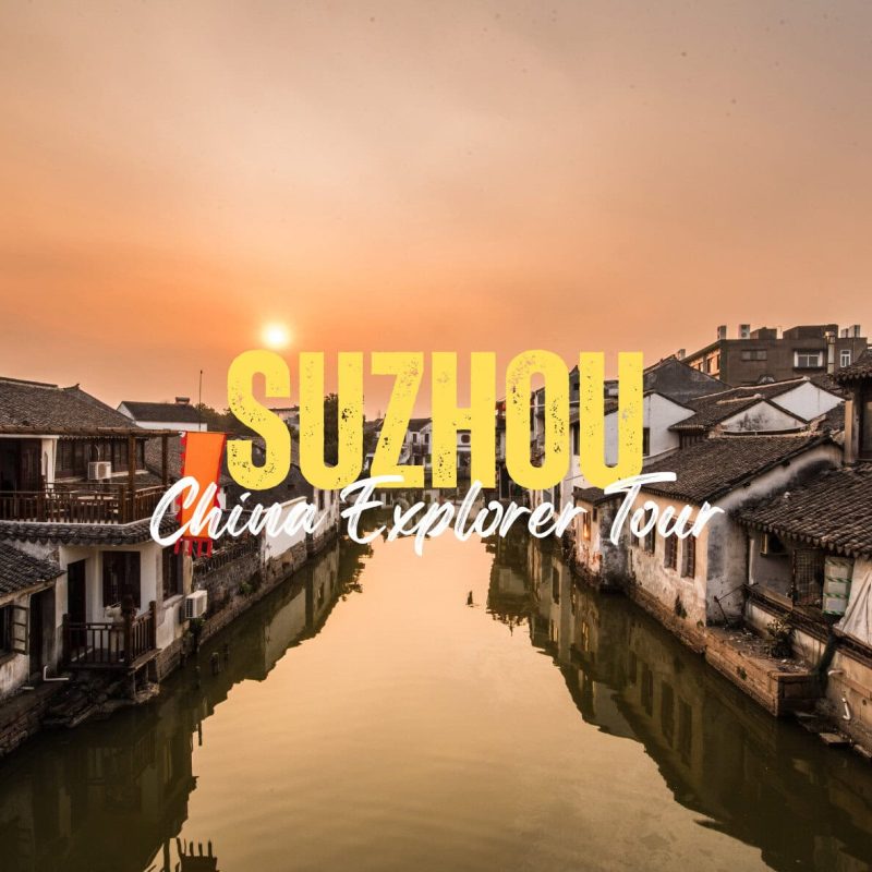 Suzhou,Jiangsu,China tour Sunset over a historic Suzhou canal with bold yellow text reading 'SUZHOU' and white script 'China Explorer Tour' overlaying the scene.