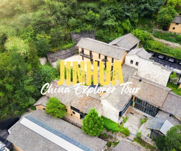 Jinhua,Zhejiang,Chinatravel Aerial view of a traditional Chinese village with tiled roofs and lush green hills, overlaid by bold yellow 'JINHUA' and white script text.