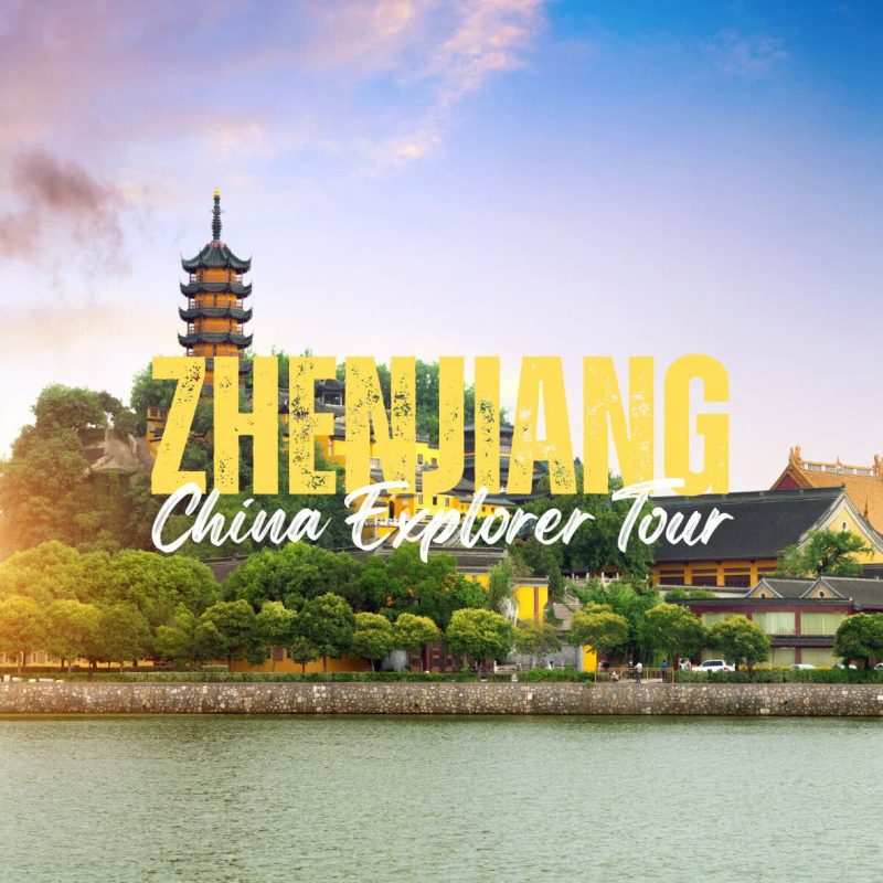 Zhengjiang,Jiangsu,China tour Promotional banner for ZHENJIANG China Explorer Tour with a multi-tier pagoda beside a river and traditional buildings at sunset.