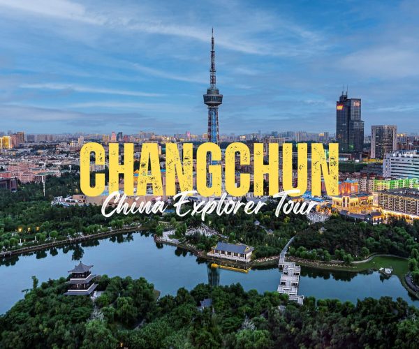 Changchun,Jilin,China tour Aerial view of Changchun with a river park in the foreground and a city skyline; large yellow text reading CHANGCHUN with white script 'China Explorer Tour' overlaying the scene.