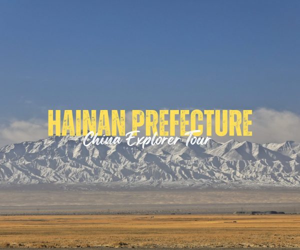 Hainan Prefecture,Qinghai,China tour Travel banner promoting Hainan Prefecture: 'China Explorer Tour' over a snowy mountain range and desert foreground, blue sky above