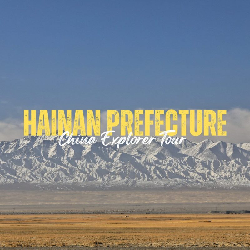 Hainan Prefecture,Qinghai,China tour Travel banner promoting Hainan Prefecture: 'China Explorer Tour' over a snowy mountain range and desert foreground, blue sky above