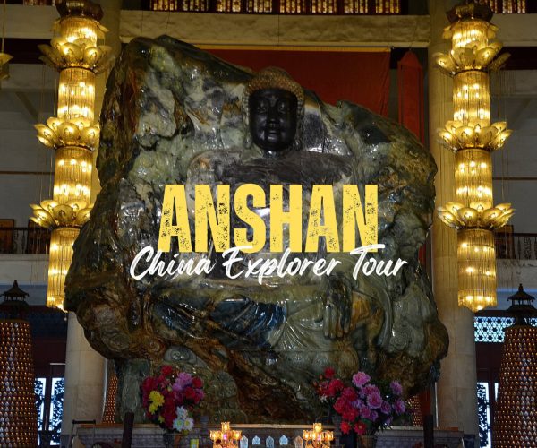 Anshan,Liaoning,China tour Stone statue of a seated figure in a lit temple, with bold yellow 'ANSHAN' and white cursive 'China Explorer Tour' text overlaid