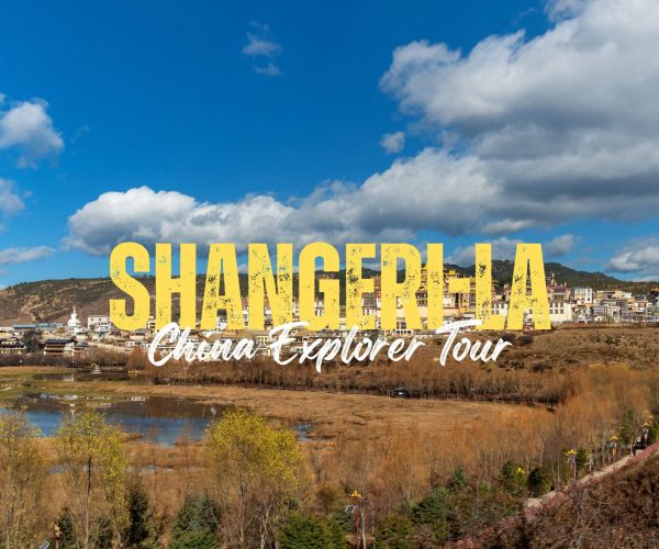 Shangri-La,Yunan,Chinatravel Promotional banner for Shangri-La: China Explorer Tour over a hillside town with a blue sky backdrop.