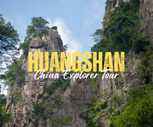 Huangshan,Anhui,China tour Large yellow 'HUANGSHAN' with white 'China Explorer Tour' over rugged rock formations and trees.