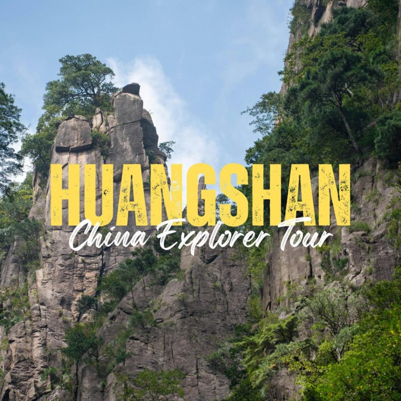 Huangshan,Anhui,China tour Large yellow 'HUANGSHAN' with white 'China Explorer Tour' over rugged rock formations and trees.