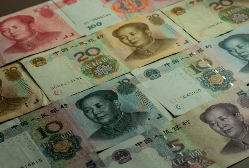 How to Exchange Money for Your China Tour, RMB, china, chinaexplorertour, Several Chinese yuan banknotes featuring Mao Zedong, in different colors and denominations (e.g., 100, 20, 50).