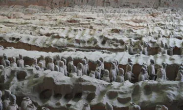 Terra Cotta Warriors, xi'an, china, china tour, Row upon row of life-size terracotta soldiers standing in an ancient excavated pit, part of the Terracotta Army display.
