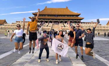 the forbidden city, beijing, china, china tour, Group of friends jumping in front of the Forbidden City’s main hall, sunny day, wearing casual summer clothes and sunglasses.