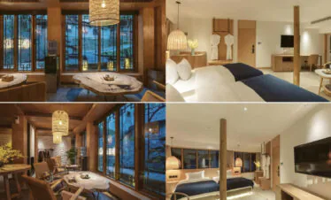 Sanchunli Boutique Inn, guizhou, china, china tour, Open-plan hotel suite with twin beds, wooden beams, and a sitting area framed by large grid windows at dusk/evening light.