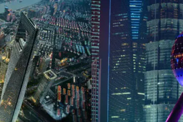 Shanghai City Tours, china tour, Nighttime city skyline with illuminated skyscrapers and brightly lit streets viewed from above, neon reflections on glass façades.