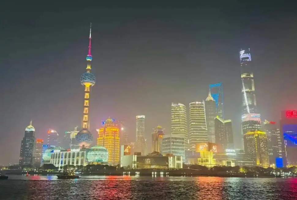 huangpu, shanghai, china, chinaexplorertour, Night view of Shanghai skyline across the river featuring the Oriental Pearl Tower and illuminated skyscrapers at night from the water's edge