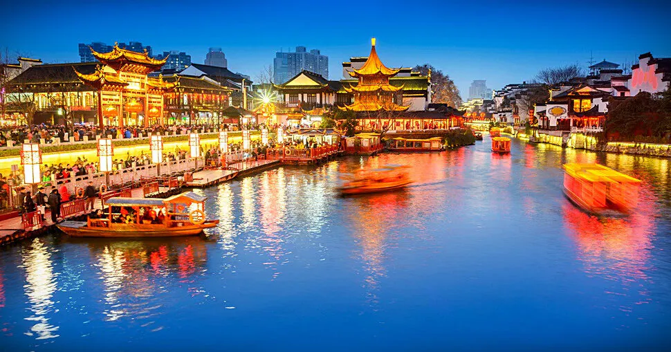 Fu Zi Temple, nanjing, jiangsu, china tour, Night canal scene in a traditional Chinese town with illuminated pavilions and boats on the water along a lit promenade.