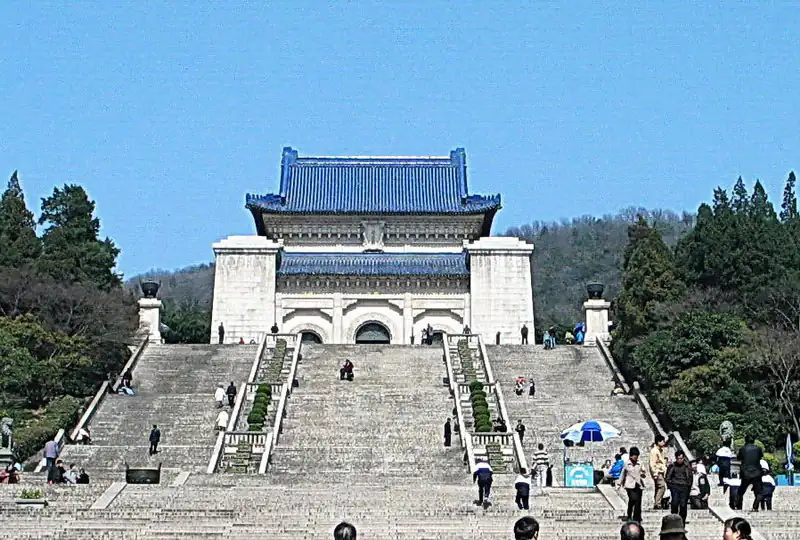 Sun Yat-sen Mausoleum, Nanjing, Jiangsu, chinatrip, Stone staircase leads up to a blue-roofed traditional Chinese gate at a hilltop, with visitors and surrounding trees on either side.