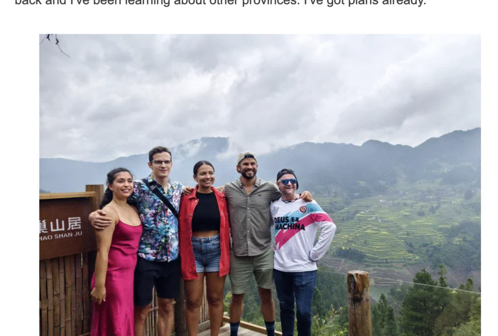 China explorer tour xinhua, chinatrip, Five tourists pose together on a wooden viewing deck overlooking terraced fields and misty mountains in Leishan County, Guizhou, China.
