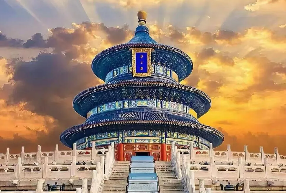 Circular blue-tiled pagoda (Temple of Heaven) atop steps leading to the shrine, with a golden sunset sky behind us.