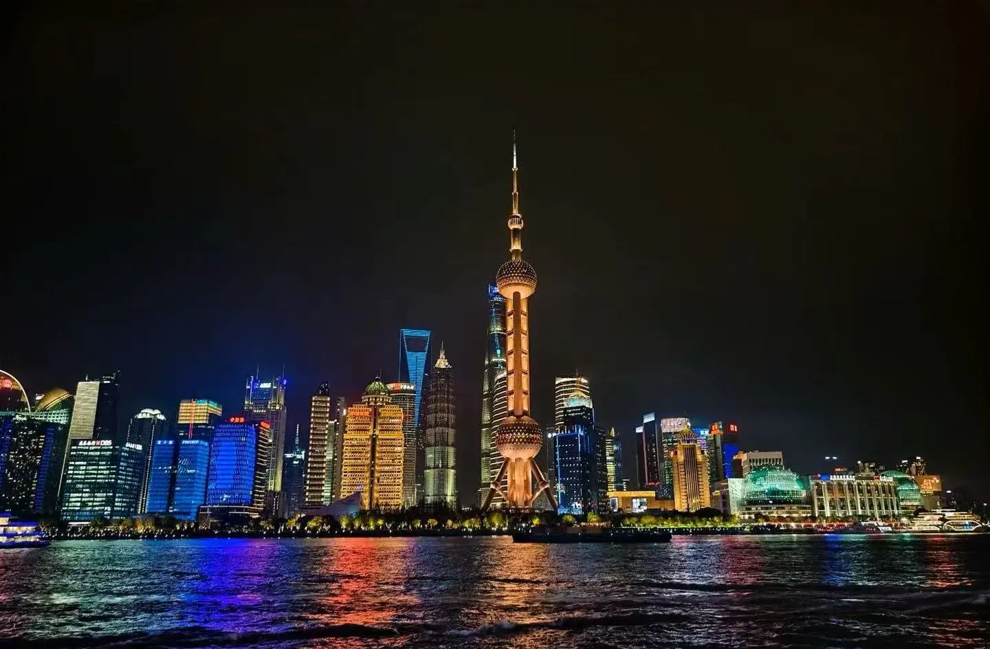 Pearl Tower,Shanghai,Chinatour Night view of Shanghai skyline along the Huangpu River, with the Oriental Pearl Tower lit up on the horizon.