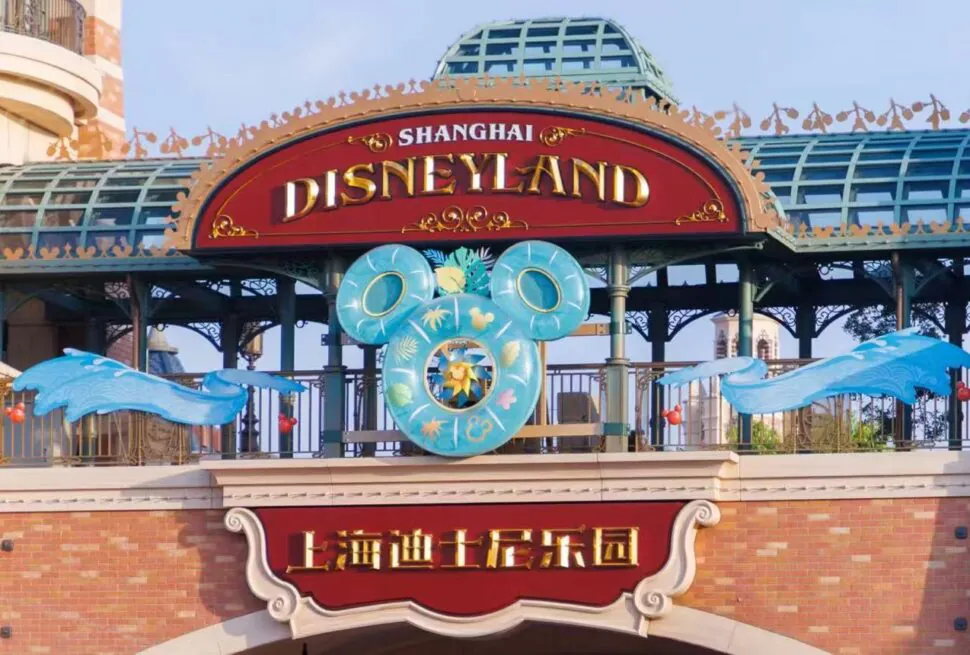 Entrance sign to Shanghai Disneyland with a large decorative Mickey Mouse ears sculpture above the red and gold signage.