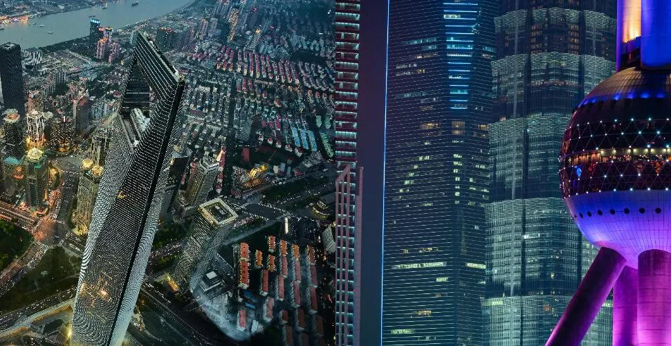 Night-time aerial view of a dense modern city skyline with illuminated skyscrapers and a futuristic tower on the right.