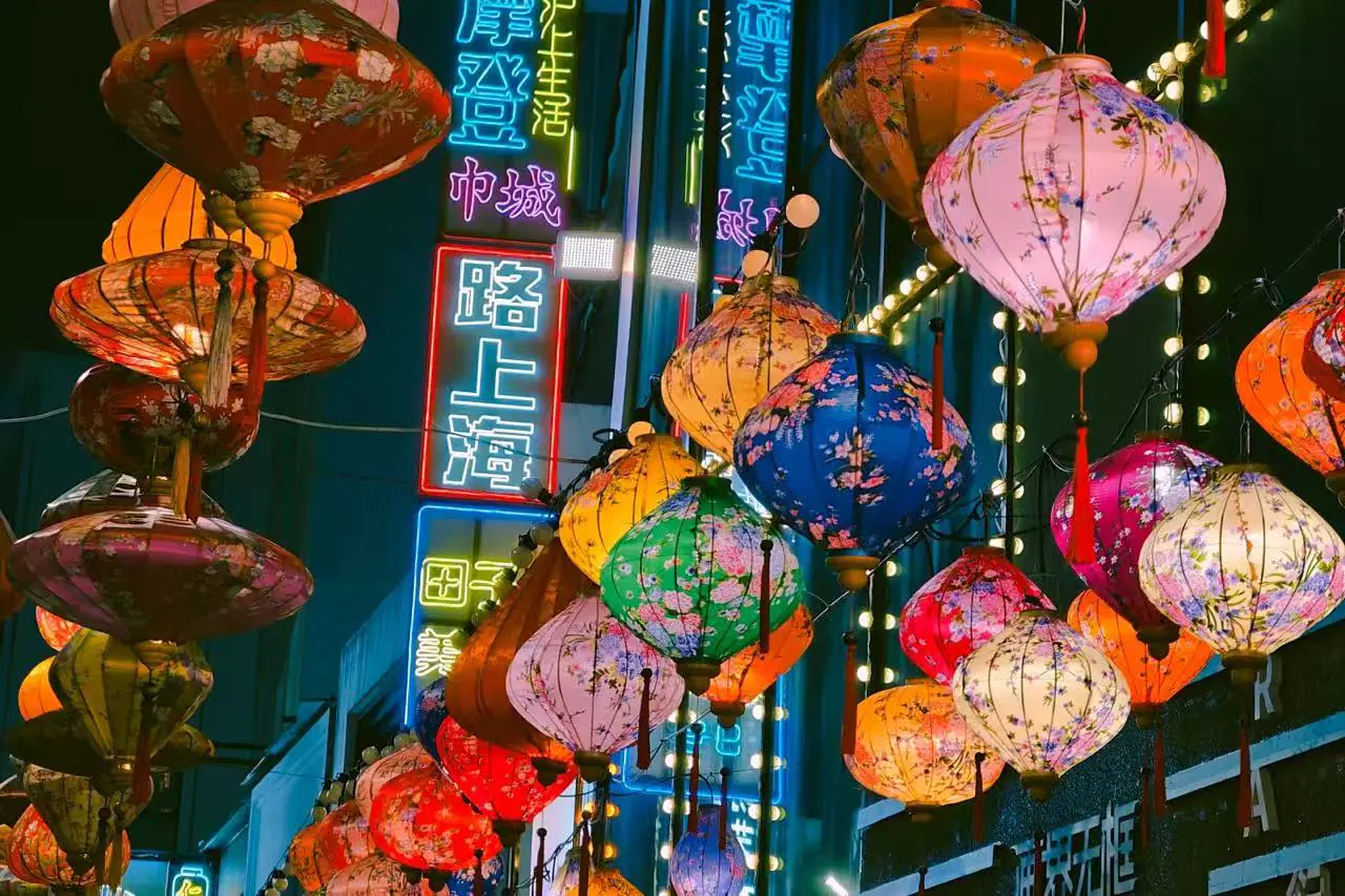 Tianzifang,Shanghai,Chinatour Colorful Chinese lanterns hanging above a night market street with neon signs in blue and red.