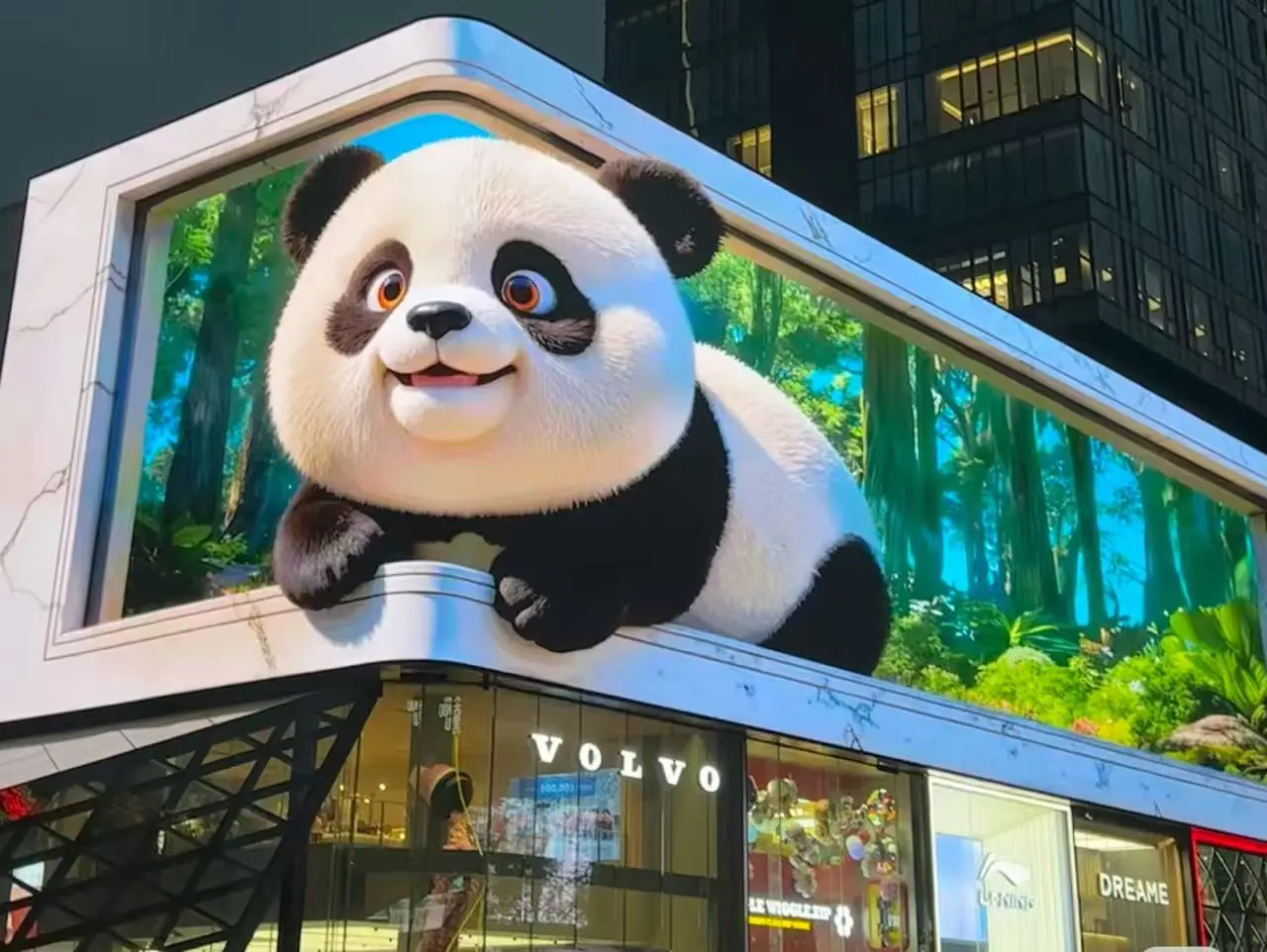 Giant panda mascot perched on a building billboard above a Volvo storefront in a city setting.
