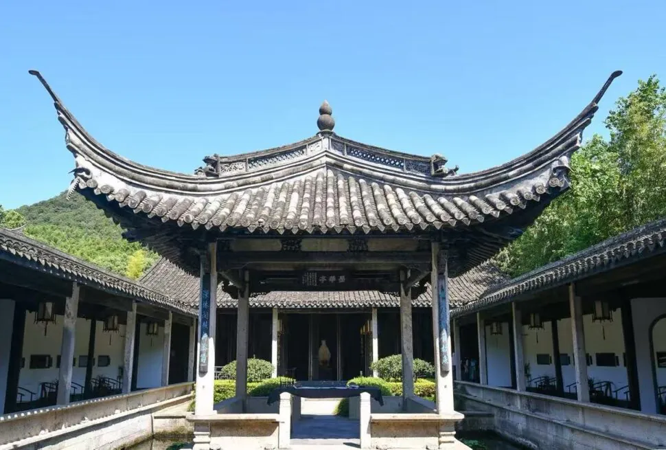 Orchid Pavilion,Shaoxing,Chinatour Traditional Chinese courtyard with a central pavilion and curved tiled roof, surrounded by colonnades.