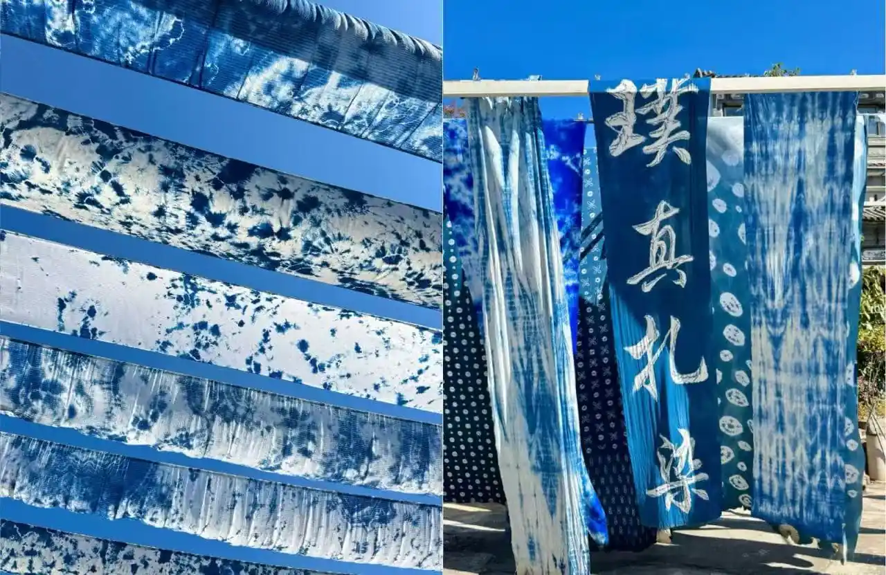 Blue tie-dyed fabric strips hang vertically, forming an outdoor textile display.Zhoucheng Village,Dali,Yunnan,Chinatravel