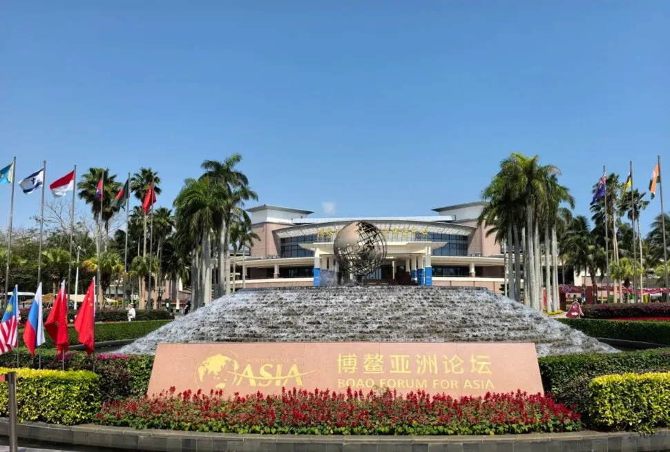 Bo’ao Forum for Asia Conference Center,Qionghai,Hainan,Chinaexplorertour Boao Forum for Asia sign in front of a tiered fountain and globe sculpture, with flags and palm trees.