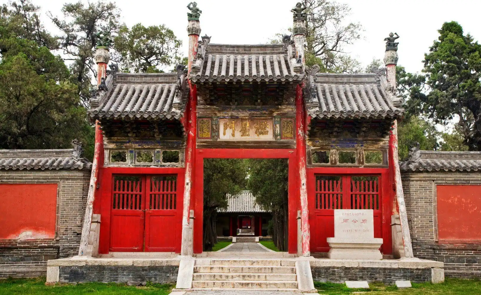 Confucius Mansion,Qufu,Chinatour Traditional Chinese temple gate with red wooden doors and ornate roof details.