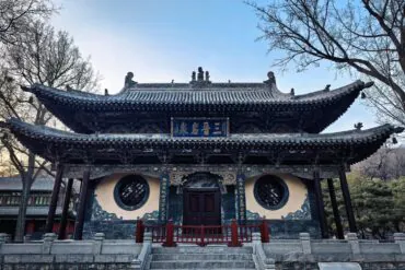 ornate Chinese temple with upturned eaves and intricate woodwork, front steps and circular lattice windows,Jinci Temple,Taiyuan, Shanxi